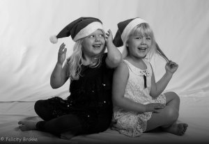 Two girls with christmas hats, black and white